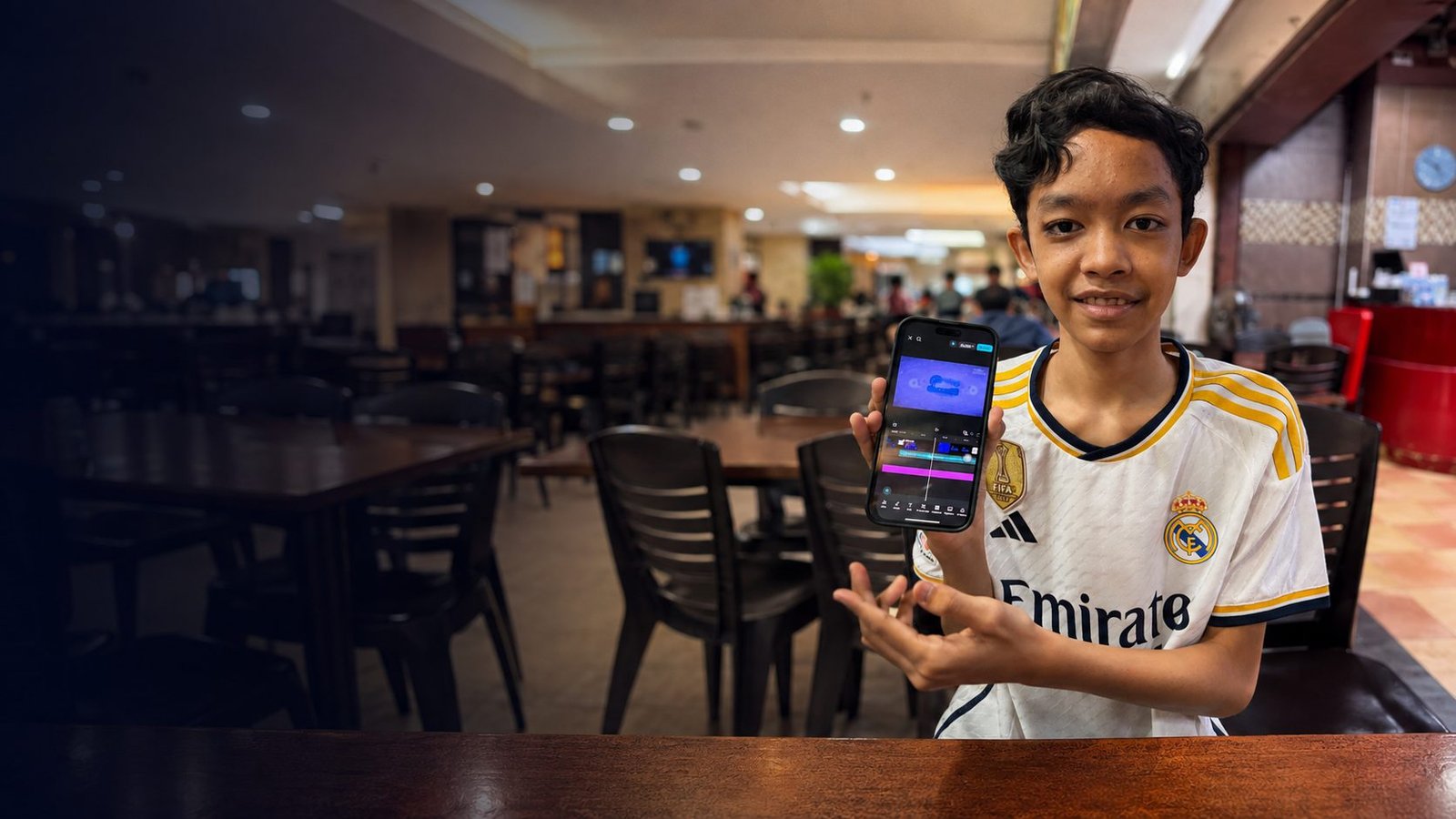 Raees, an autistic teenage pianist, editing a piano cover video on his phone