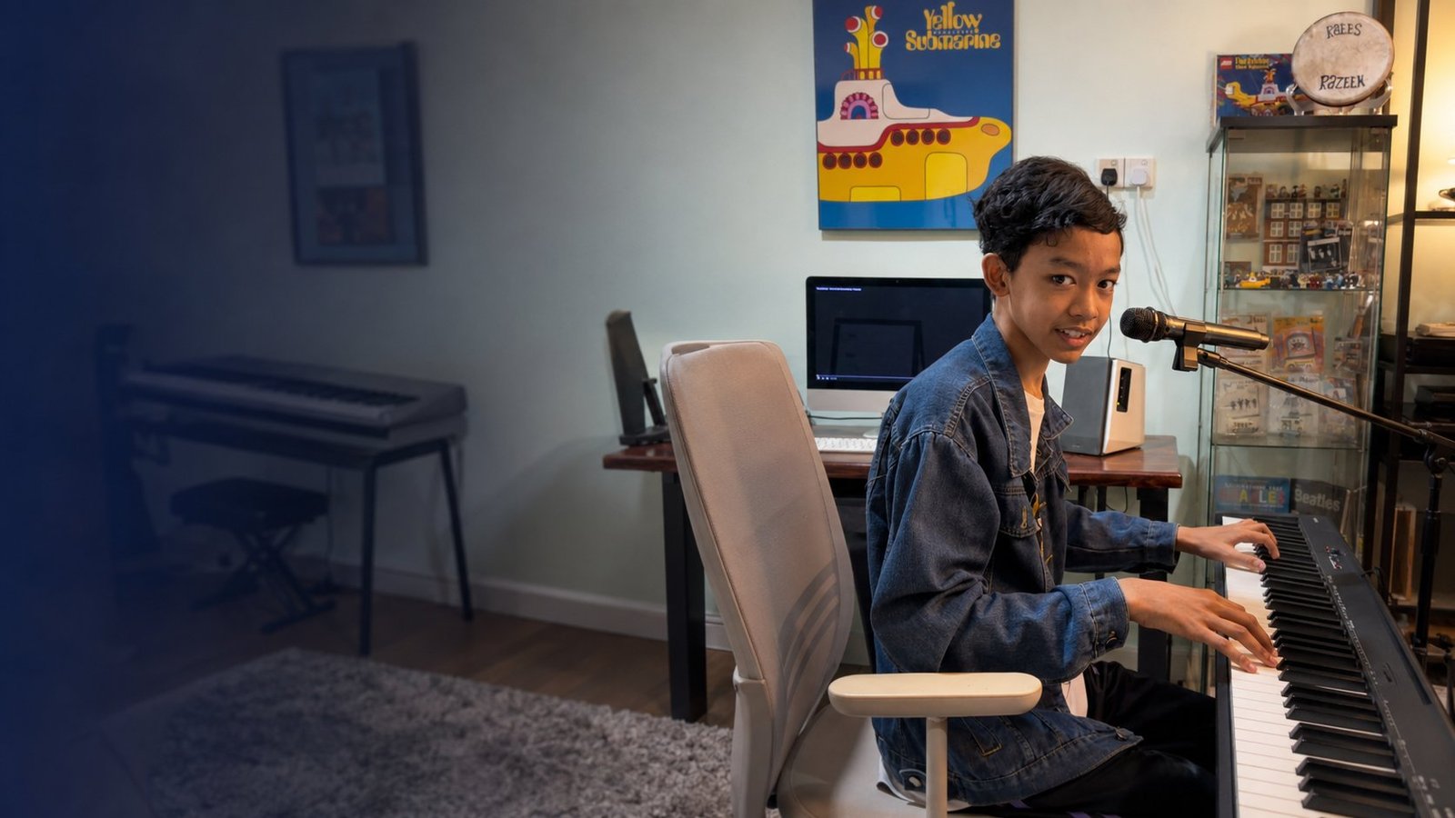 Raees, an autistic pianist, playing an electric keyboard and singing into a microphone in his home music studio