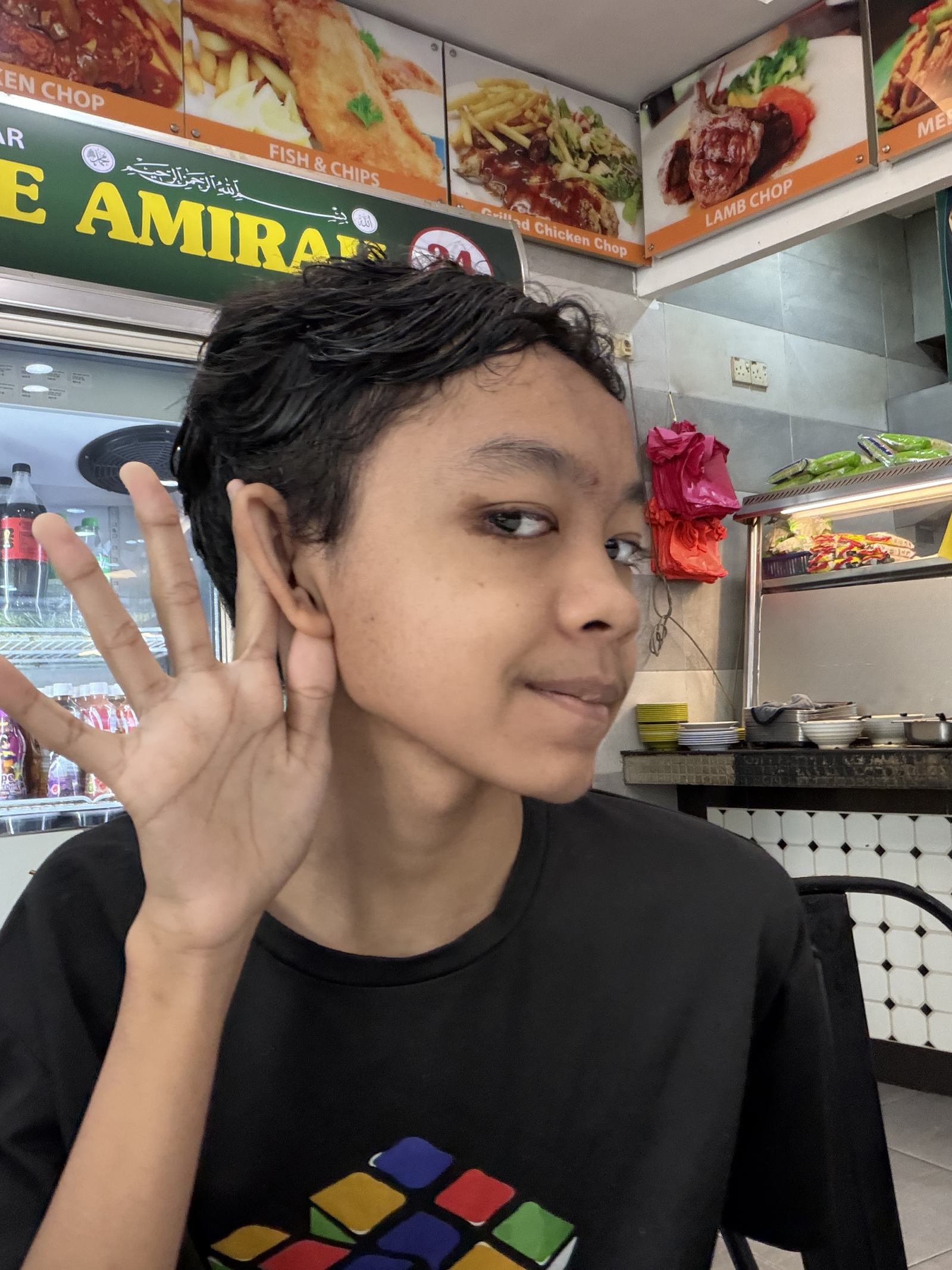 Raees Aryan Ezmir smiling at a hawker food stall